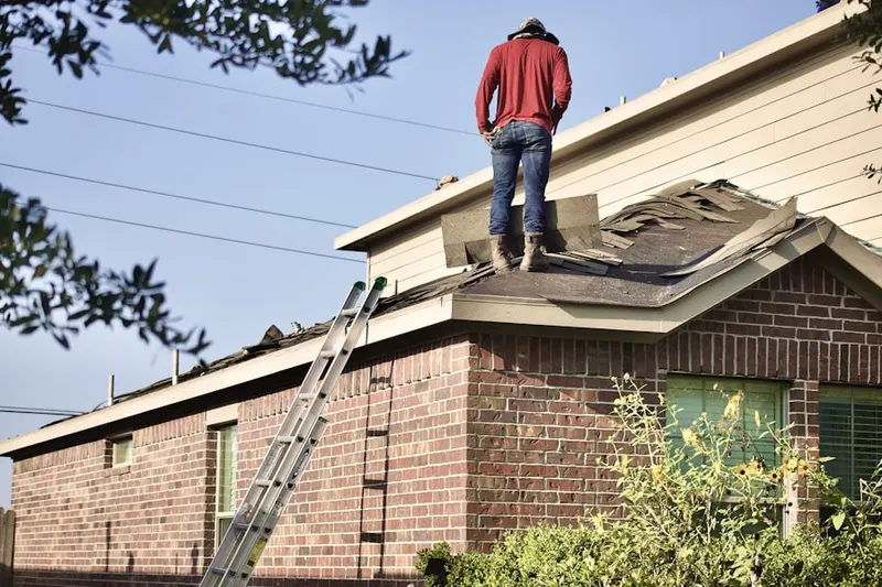 Professional roofer working on a residential roof in Downtown Wakefield